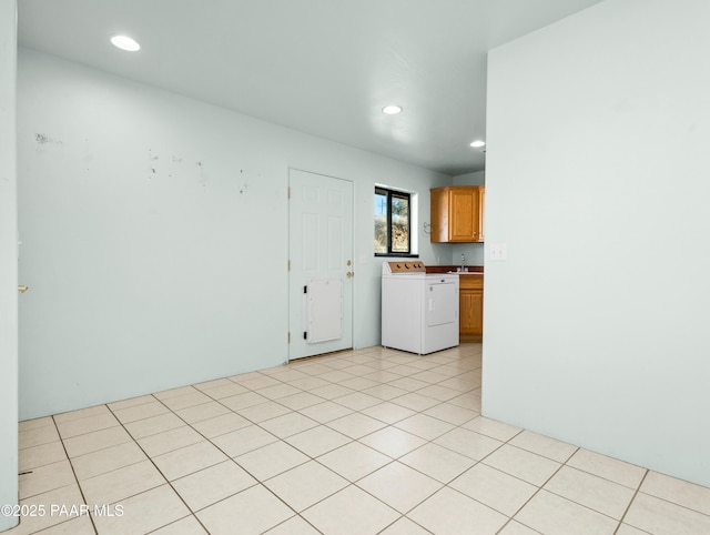 interior space featuring independent washer and dryer and light tile patterned flooring