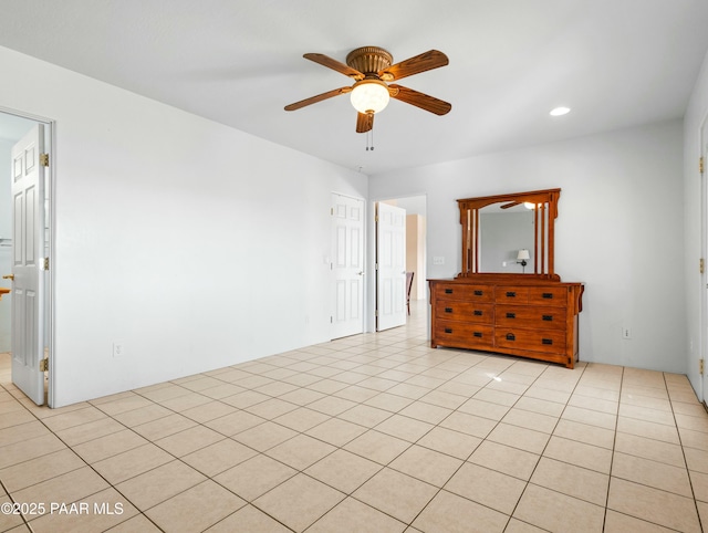 empty room featuring ceiling fan and light tile patterned flooring