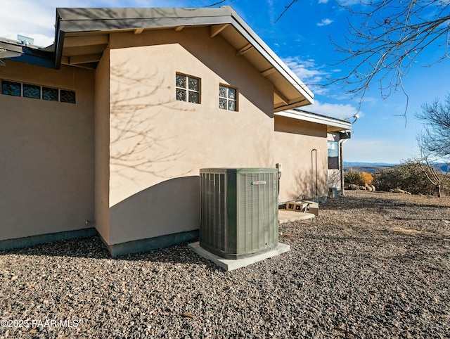 view of property exterior with a patio area and central AC