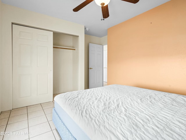 bedroom with ceiling fan, a closet, and light tile patterned flooring