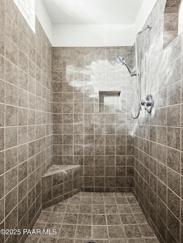 bathroom with a tile shower