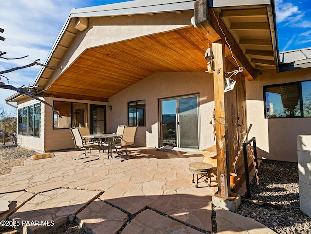 back of house with a sunroom and a patio