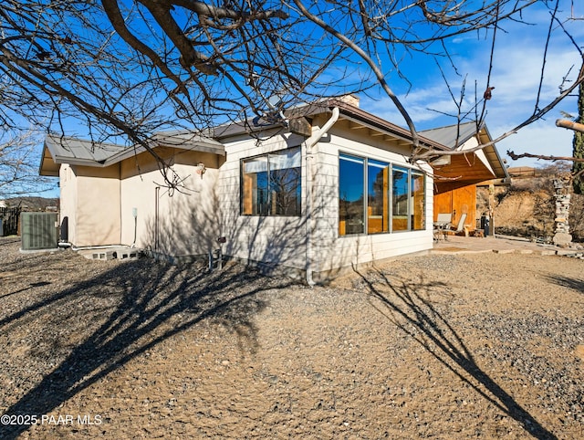 rear view of house featuring central AC and a patio area