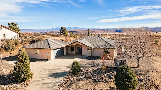 ranch-style house with a garage and a mountain view