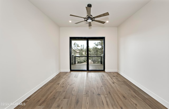 spare room with ceiling fan and wood-type flooring