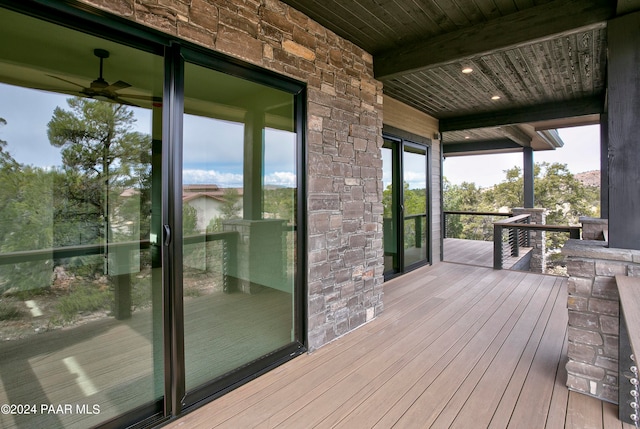 deck with ceiling fan and a porch