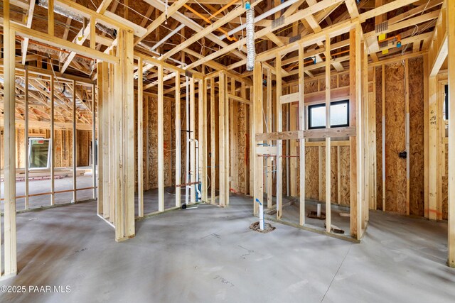 carpeted empty room featuring a fireplace, a raised ceiling, and ceiling fan