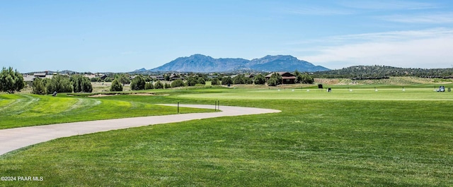 view of community featuring a mountain view and a lawn