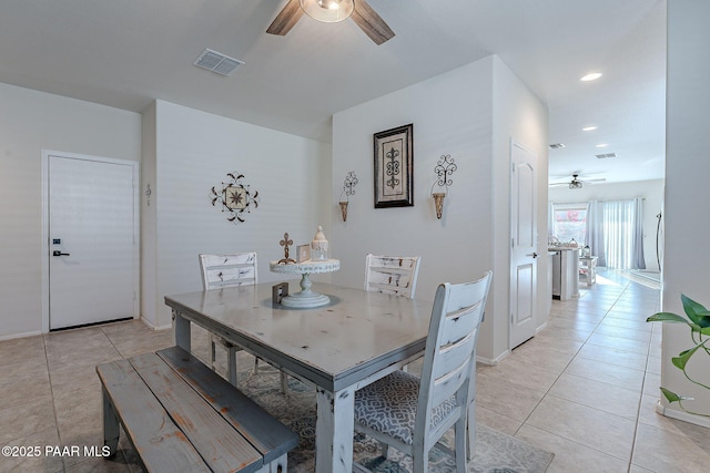 tiled dining room featuring ceiling fan