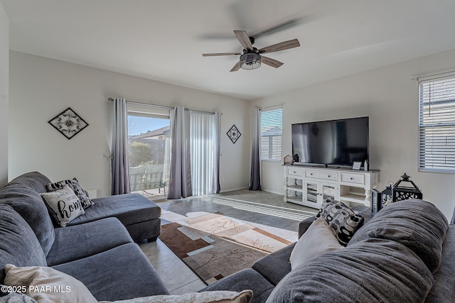 tiled living room with ceiling fan and plenty of natural light