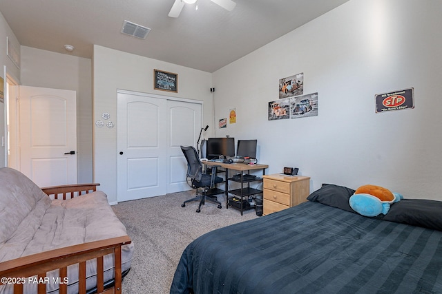 carpeted bedroom with ceiling fan and a closet