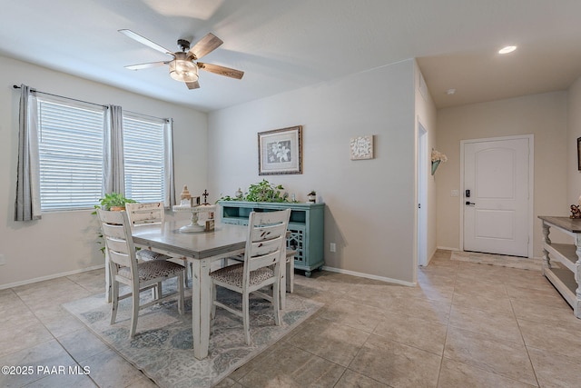 tiled dining space with ceiling fan