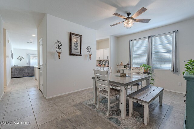 tiled dining space with ceiling fan