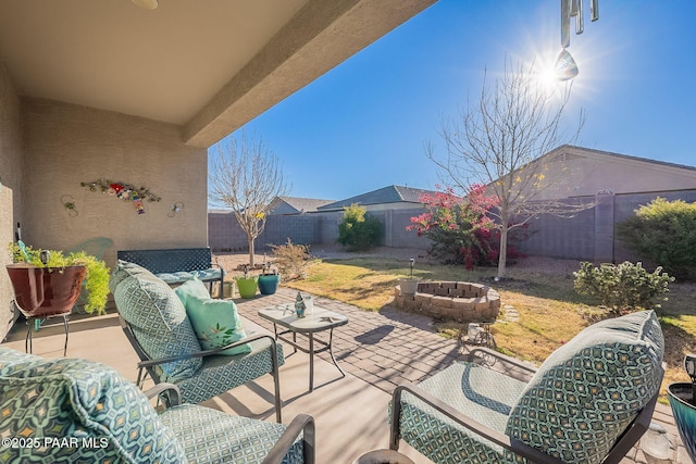 view of patio with an outdoor living space with a fire pit