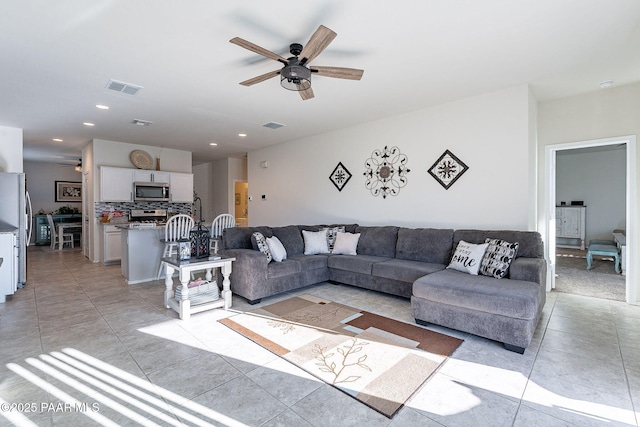 living room featuring ceiling fan and light tile patterned floors