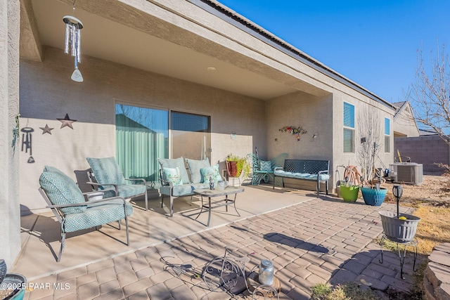 view of patio / terrace with an outdoor living space and central air condition unit