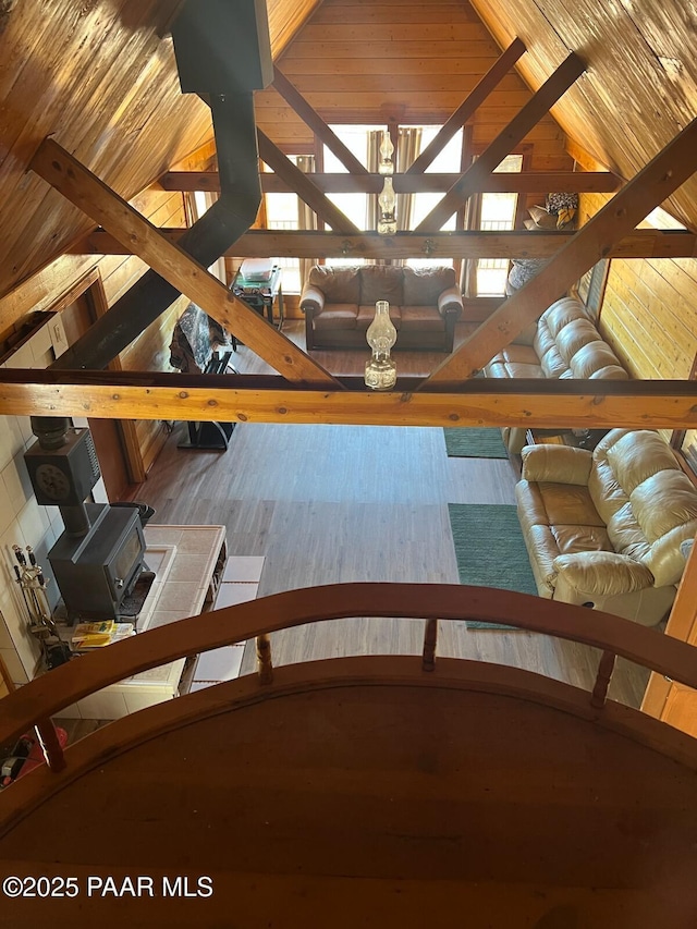 unfurnished living room featuring wooden ceiling, wood finished floors, and vaulted ceiling with beams