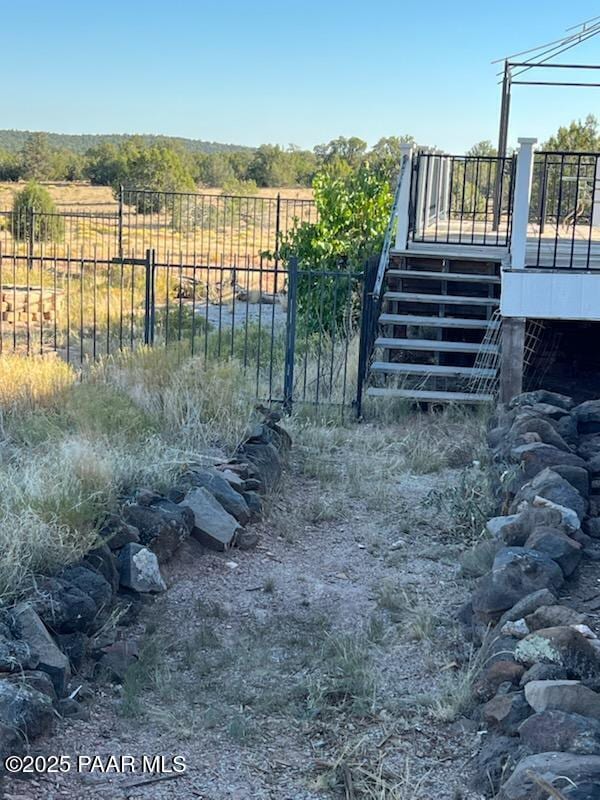 view of yard featuring fence and a wooden deck