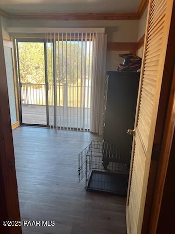 interior space with wood finished floors and ornamental molding