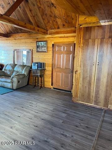 living area featuring wooden walls, wooden ceiling, vaulted ceiling with beams, and wood finished floors