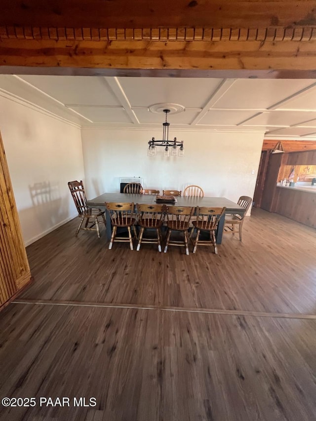 unfurnished dining area featuring a chandelier and wood finished floors