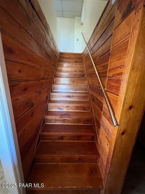 stairs with wood walls