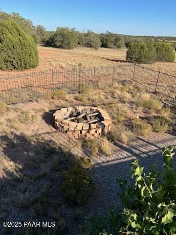 view of yard featuring a rural view and fence