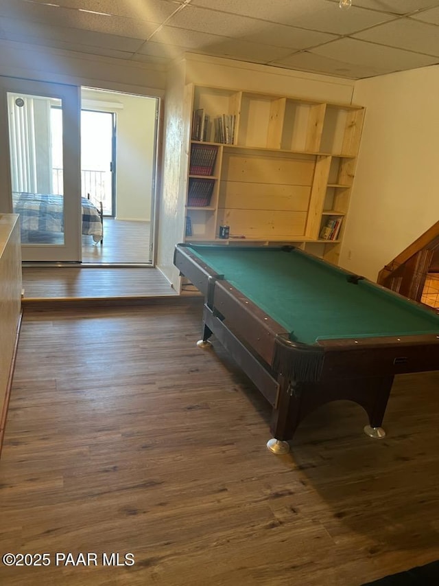 recreation room featuring pool table, a paneled ceiling, and wood finished floors