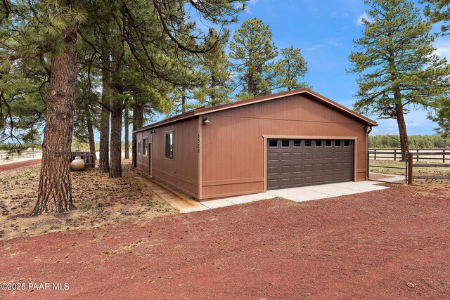 8222 N Spring Valley Rd, Parks, AZ 86018 - view of side of home featuring an outdoor structure, a garage, and fence