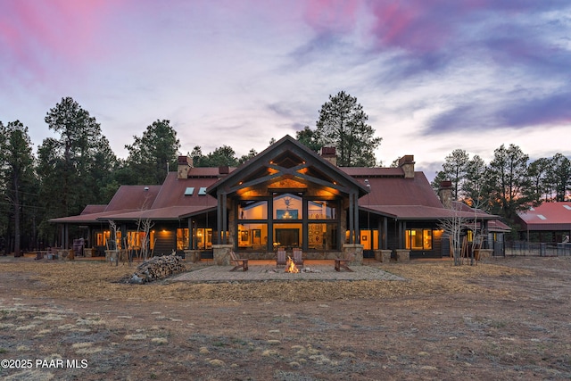 8222 N Spring Valley Rd, Parks, AZ 86018 - back of house with a fire pit, a chimney, and metal roof