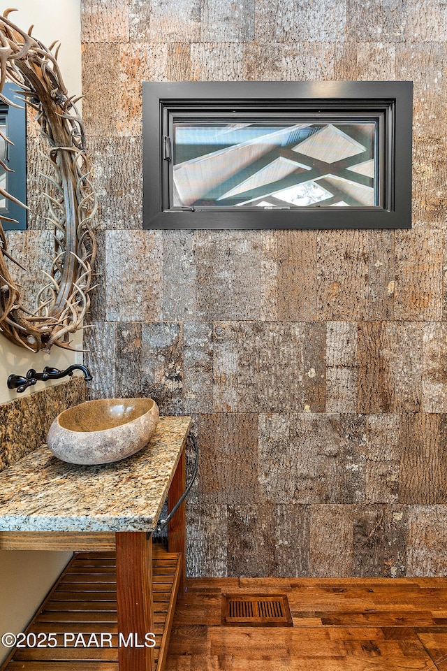 8222 N Spring Valley Rd, Parks, AZ 86018 - bathroom featuring visible vents, wood-type flooring, and vanity