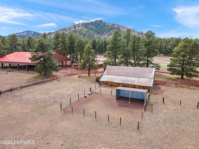 8222 N Spring Valley Rd, Parks, AZ 86018 - surrounding community with a rural view, an exterior structure, a mountain view, and an outbuilding