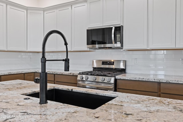 kitchen featuring white cabinets and stainless steel appliances