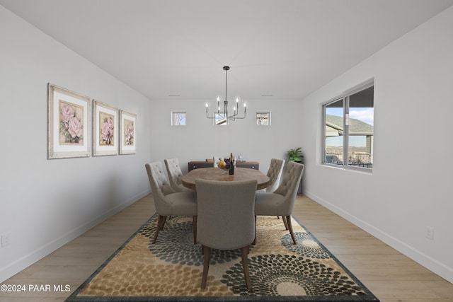 dining space featuring a chandelier and light wood-type flooring