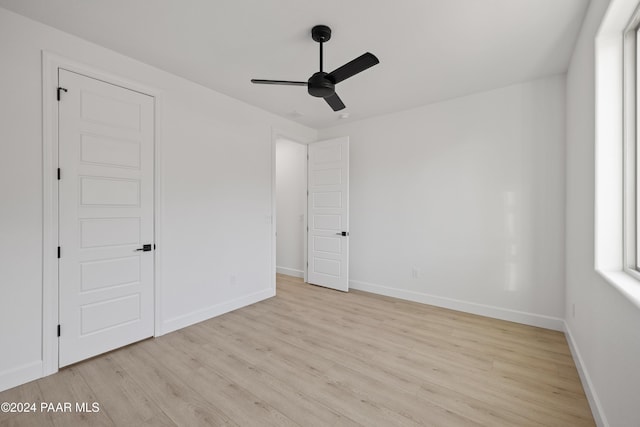 unfurnished bedroom with ceiling fan and light hardwood / wood-style floors