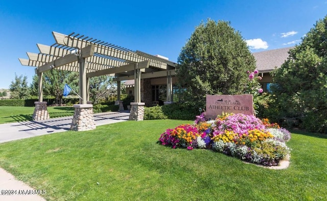 exterior space with a pergola and a lawn