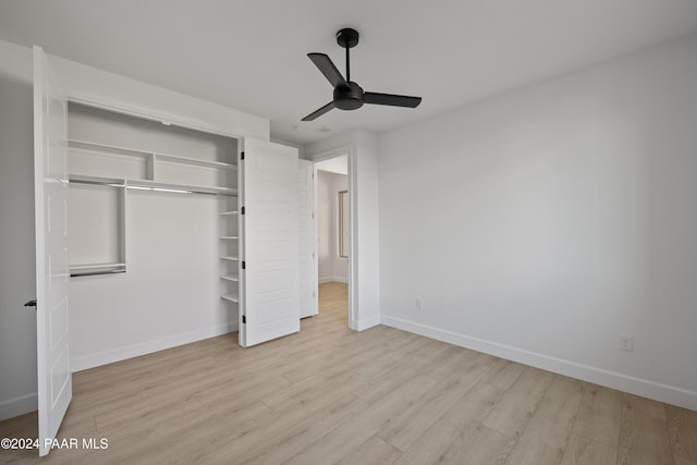 unfurnished bedroom featuring ceiling fan, a closet, and light hardwood / wood-style floors