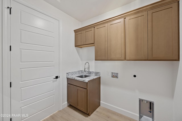 clothes washing area featuring sink, washer hookup, cabinets, electric dryer hookup, and light hardwood / wood-style floors