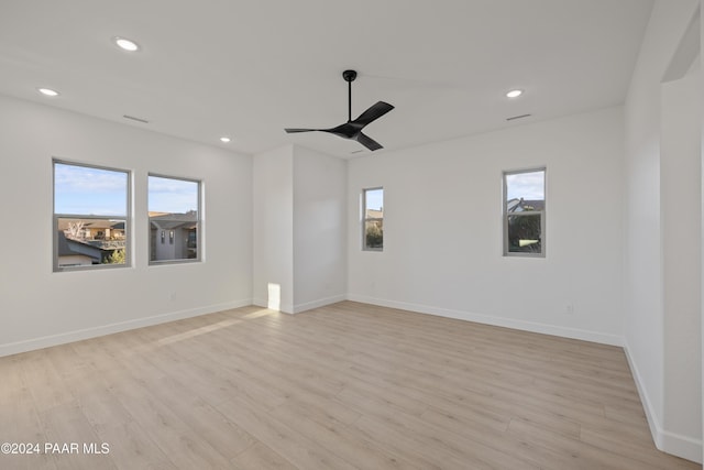 empty room featuring light hardwood / wood-style floors, plenty of natural light, and ceiling fan