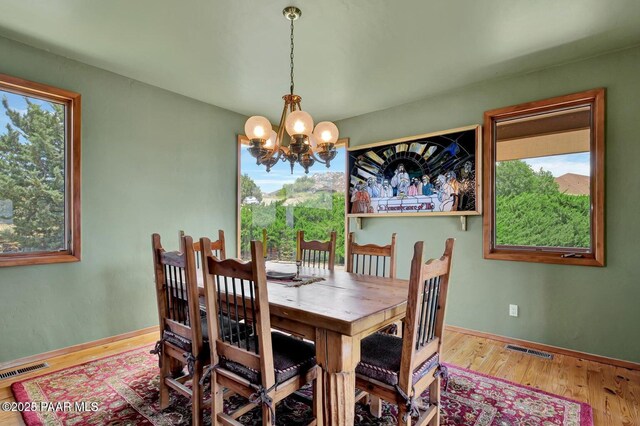 6310 N Michele Ln, Prescott, AZ 86305 - dining area with a chandelier, plenty of natural light, and wood finished floors