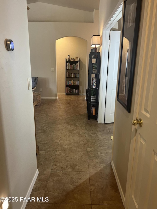 5626 N Ardmore Ave, Prescott Valley, AZ 86315 - hallway with arched walkways, baseboards, vaulted ceiling, and tile patterned flooring