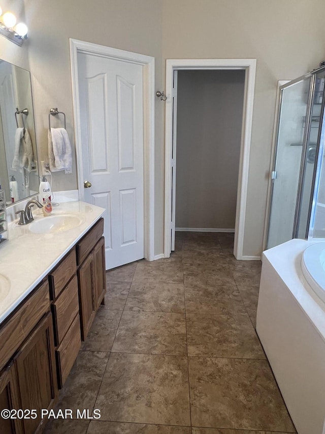 5626 N Ardmore Ave, Prescott Valley, AZ 86315 - bathroom with double vanity, a bath, a stall shower, a sink, and baseboards