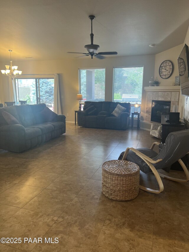 5626 N Ardmore Ave, Prescott Valley, AZ 86315 - tiled living room with a tiled fireplace, a wealth of natural light, and ceiling fan with notable chandelier