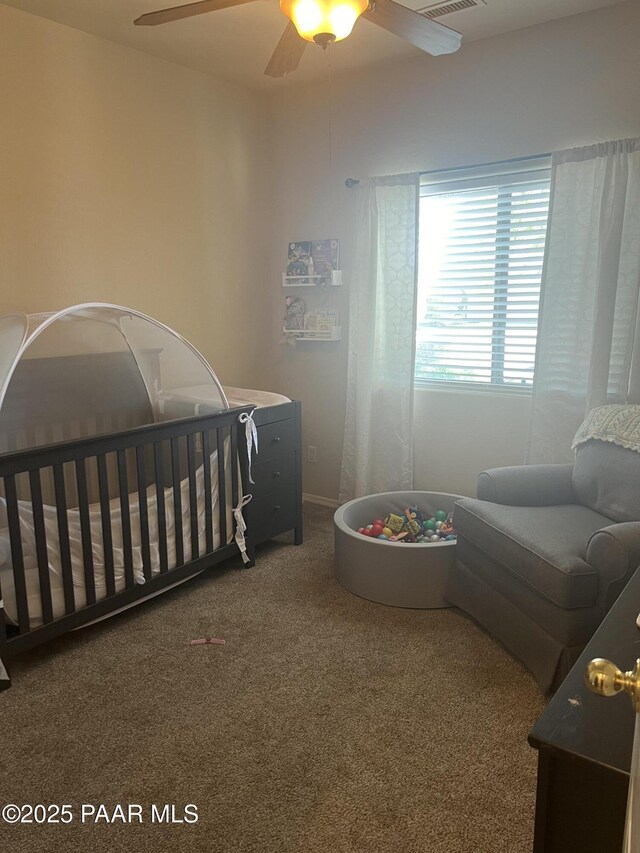 5626 N Ardmore Ave, Prescott Valley, AZ 86315 - bedroom with carpet flooring, a ceiling fan, and a crib