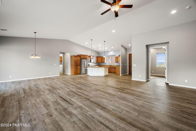 unfurnished living room with ceiling fan with notable chandelier, wood-type flooring, lofted ceiling, and sink