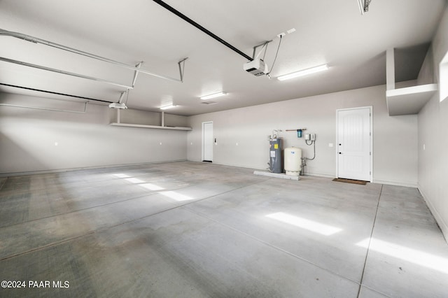 garage featuring electric water heater and a garage door opener