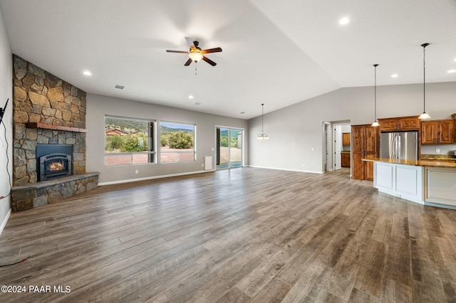 unfurnished living room with ceiling fan, a fireplace, wood-type flooring, and lofted ceiling