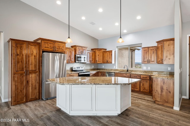 kitchen with a center island, pendant lighting, and appliances with stainless steel finishes