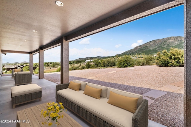 view of patio featuring a mountain view and an outdoor living space