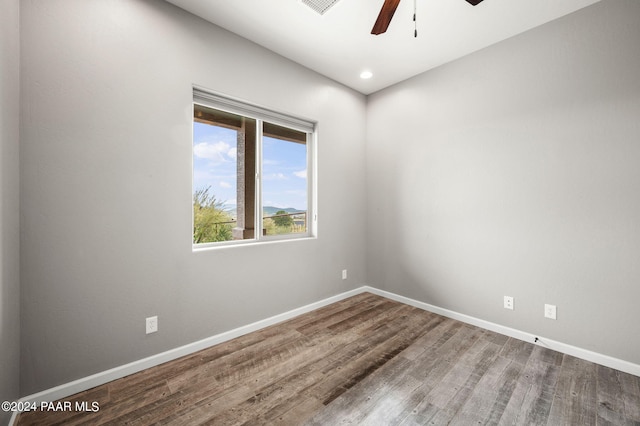 unfurnished room with ceiling fan and wood-type flooring